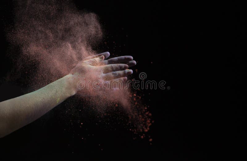 Clap hands during Holi. Red cloud of dry paint. Free space stock photo